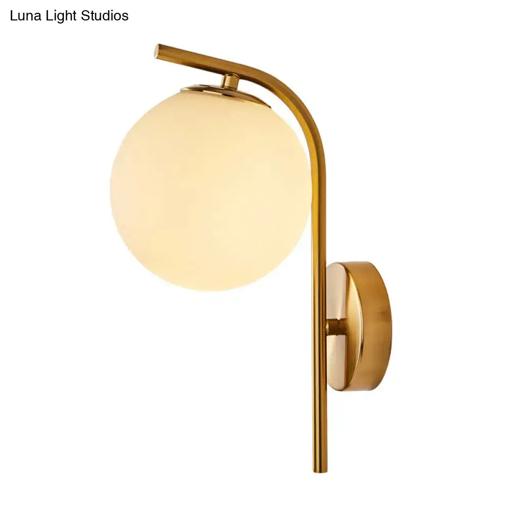 Modern brass globe bedside lamp with frosted glass for bedroom