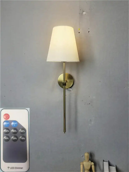 Modern brass led wall sconce with white fabric shade for bedroom