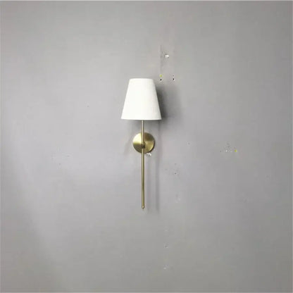 Modern brass led wall sconce with white fabric shade for bedroom