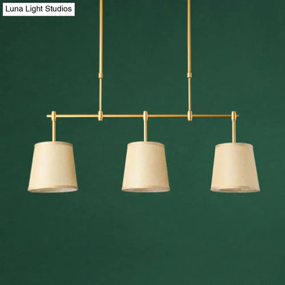 Modern brass pendant light with white green flaxen shades dining room