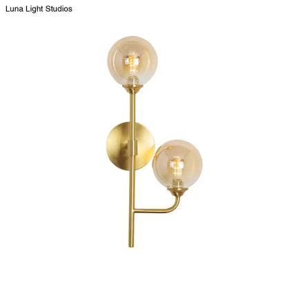 Modern brass sphere wall sconce amber & smoke gray bathroom light