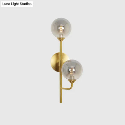 Modern brass sphere wall sconce amber & smoke gray bathroom light