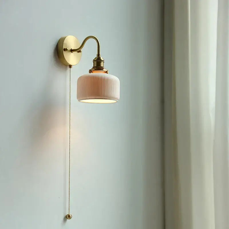 Modern brass wall lamp with ribbed glass shade – bedroom reading light