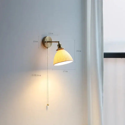 Modern brass wall lamp with ribbed glass shade – bedroom reading light