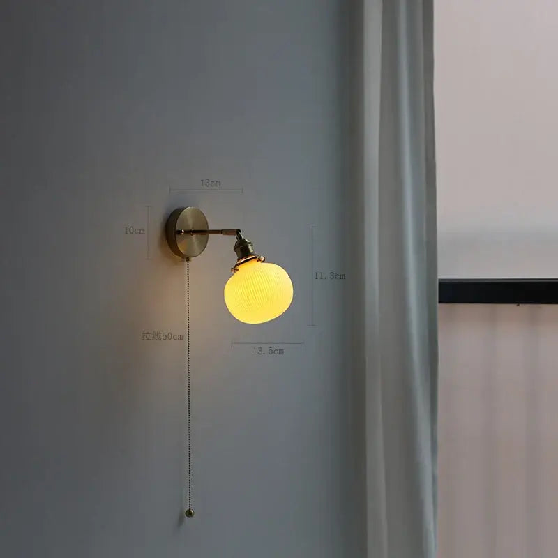 Modern brass wall lamp with ribbed glass shade – bedroom reading light