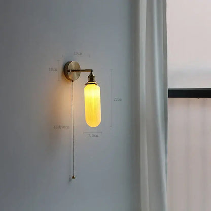 Modern brass wall lamp with ribbed glass shade – bedroom reading light