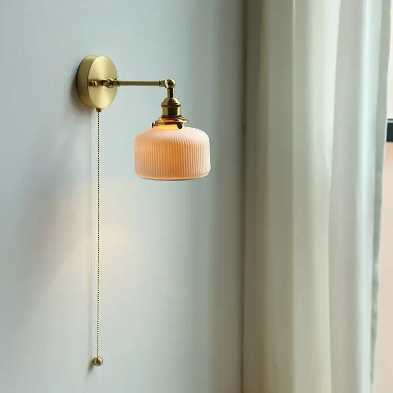 Modern brass wall lamp with ribbed glass shade – bedroom reading light