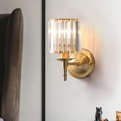 Modern brass wall light sconce with crystal shade for bedroom