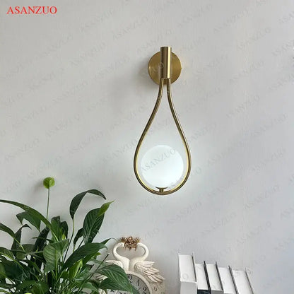Modern brass wall sconce frosted glass teardrop living room light