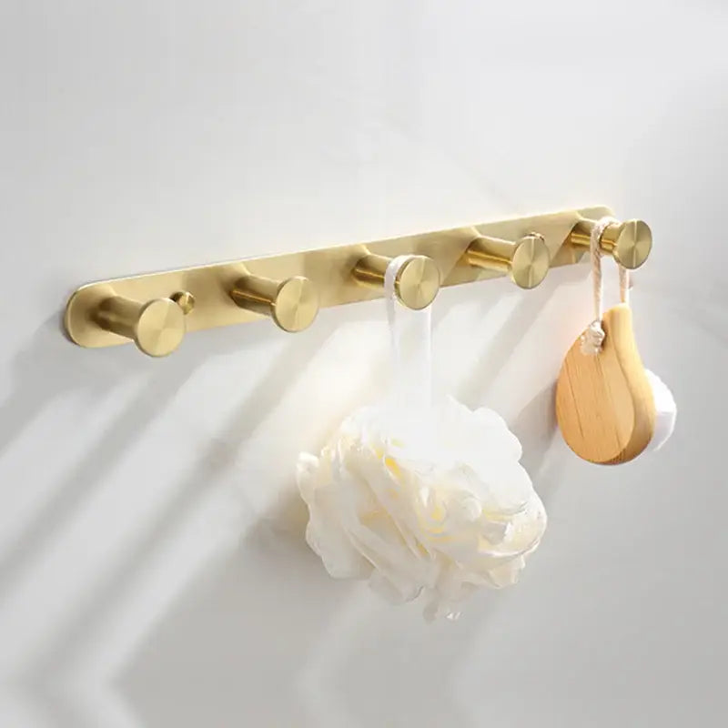 Modern brushed gold bathroom hardware set with glass soap dish