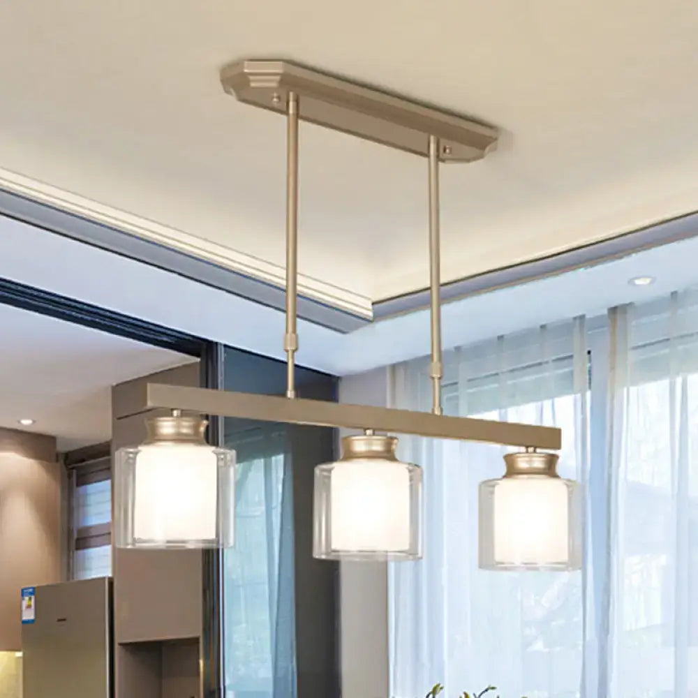 Modern brushed nickel pendant light with clear glass shade dining room