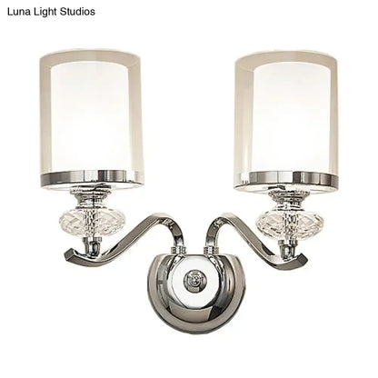 Modern chrome dual cylinder bathroom sconce with curvy arm