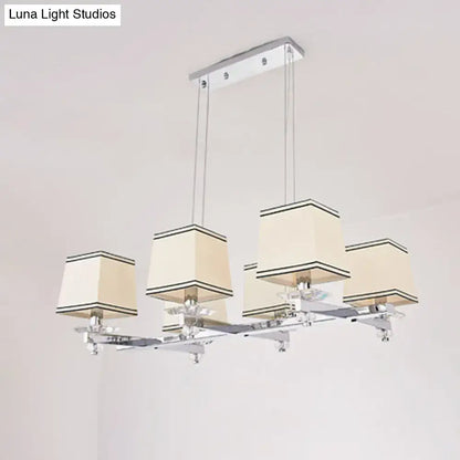 Modern chrome island pendant light with cream shades for dining rooms