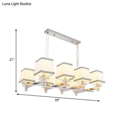 Modern chrome island pendant light with cream shades for dining rooms
