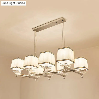 Modern chrome island pendant light with cream shades for dining rooms