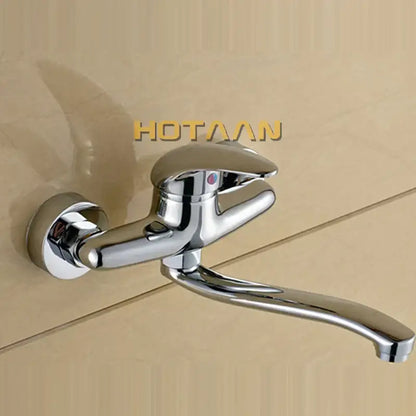 Modern chrome wall mounted kitchen tap with curved spout