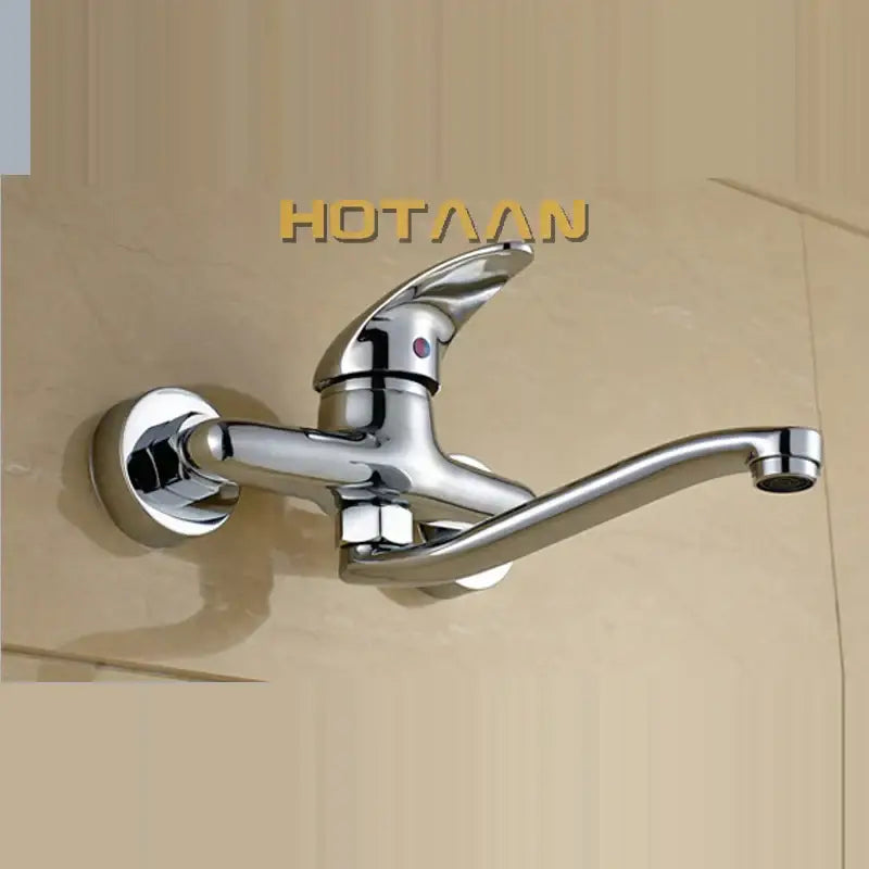 Modern chrome wall mounted kitchen tap with curved spout