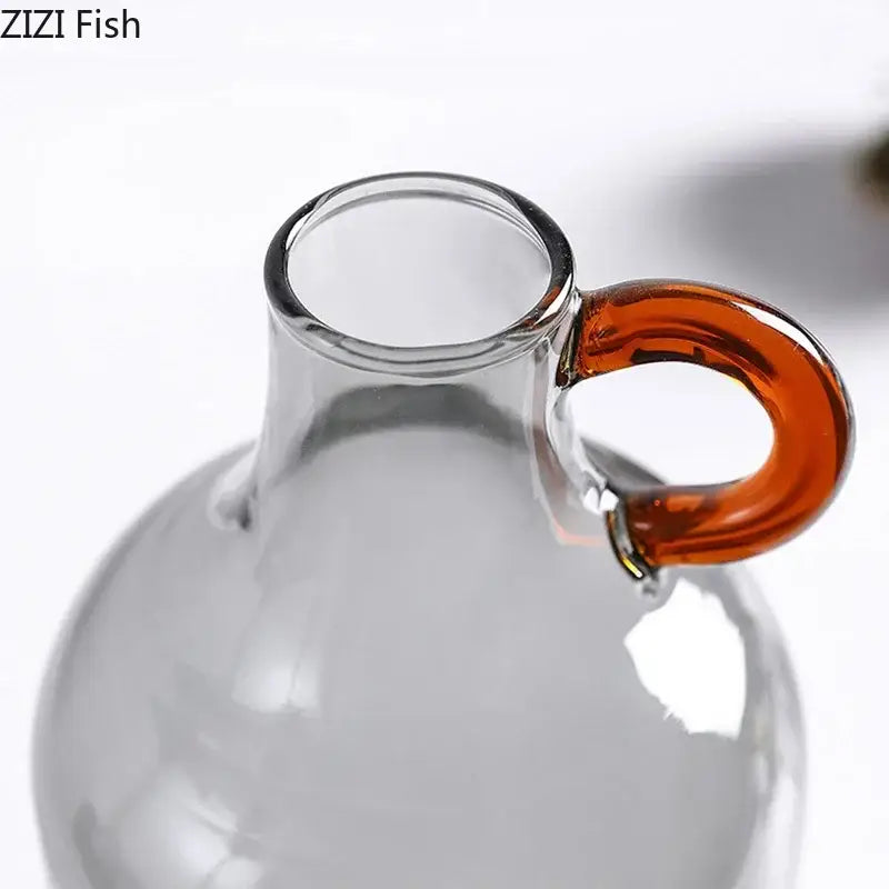 Modern clear glass vase with orange handles living room decor