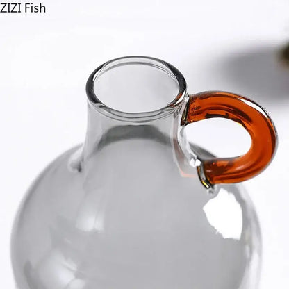 Modern clear glass vase with orange handles living room decor