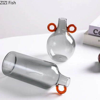 Modern clear glass vase with orange handles living room decor
