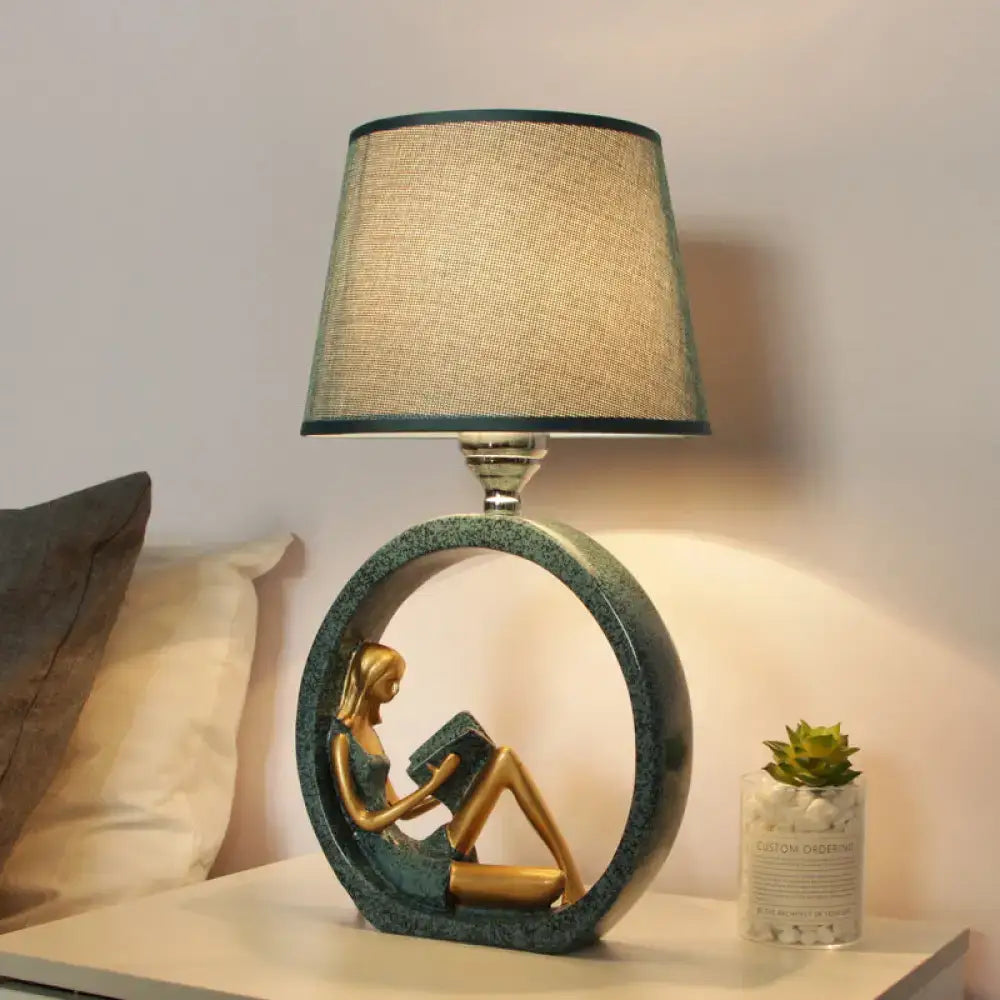 Modern girl reading teal resin night lamp with fabric shade bedroom