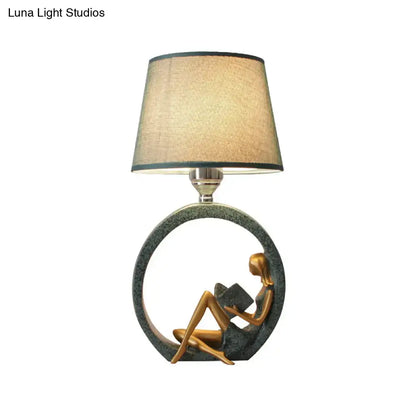 Modern girl reading teal resin night lamp with fabric shade bedroom