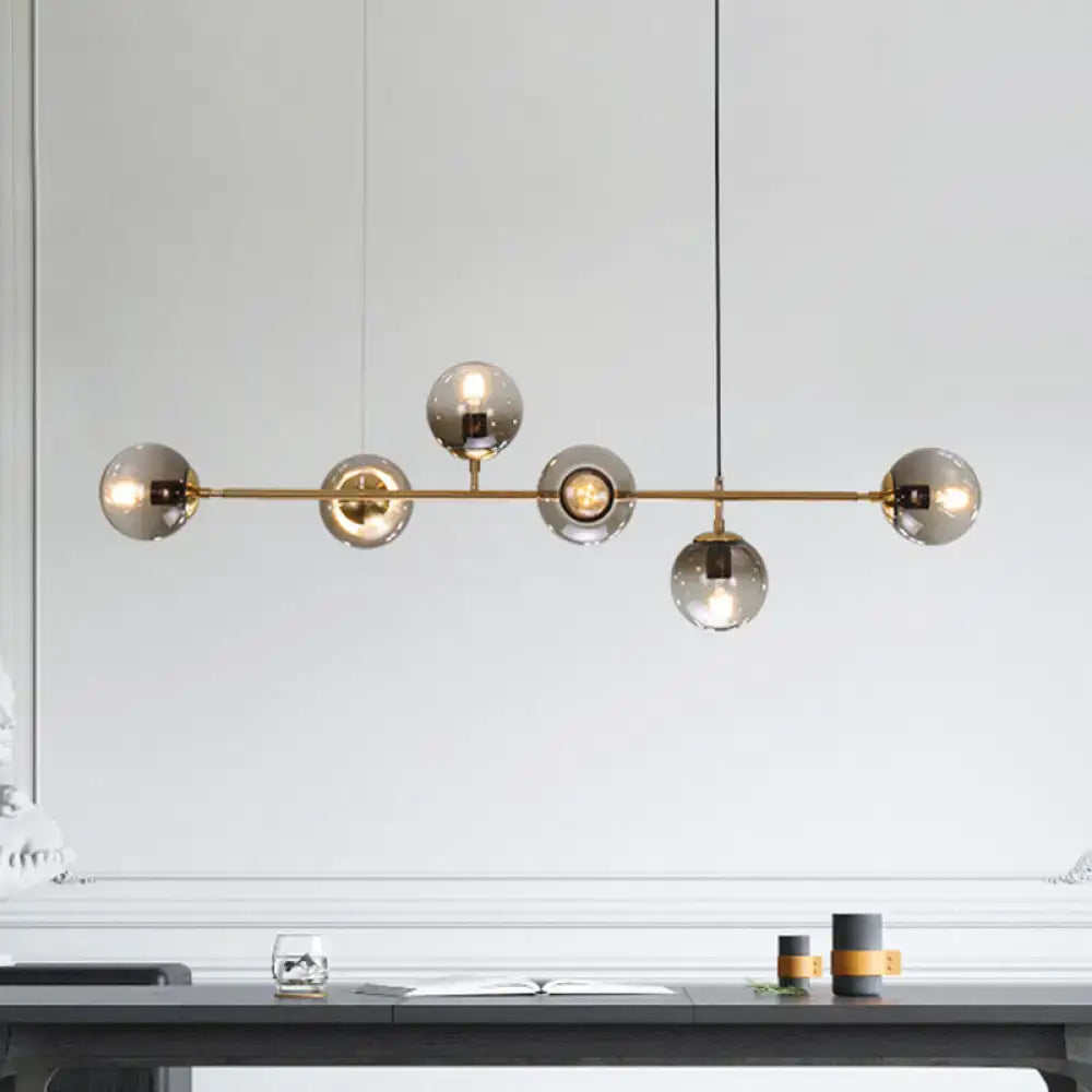 Modern gold and smoke gray globe hanging light – dining room island