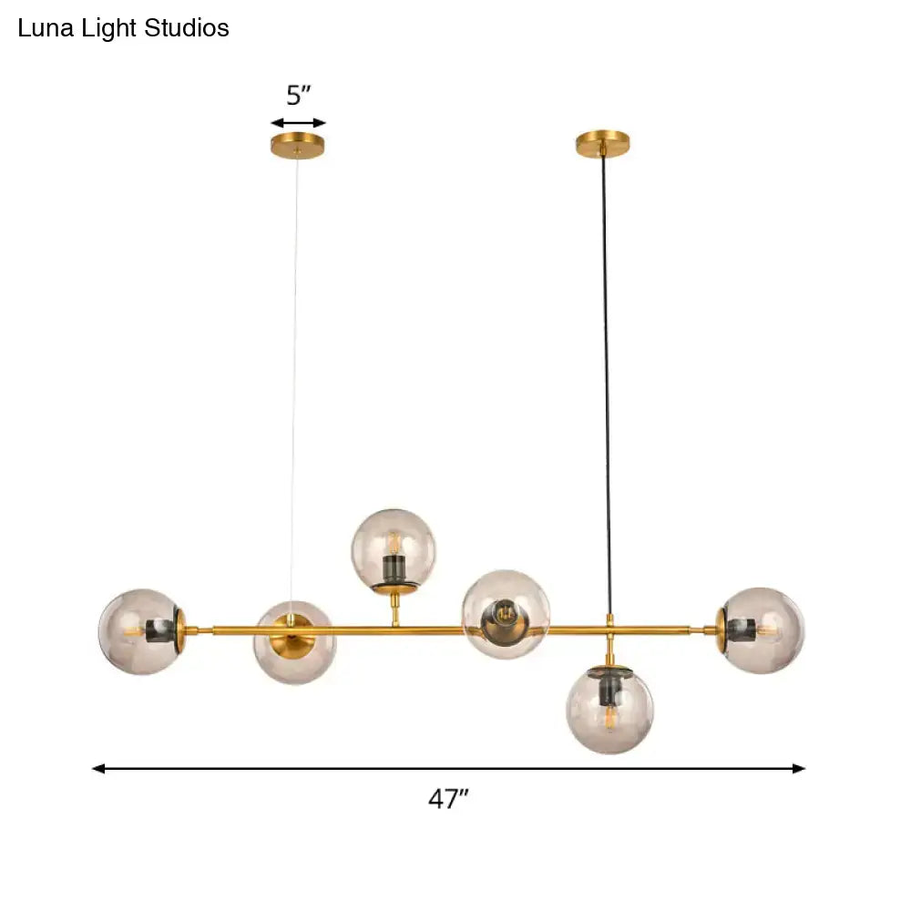Modern gold and smoke gray globe hanging light – dining room island