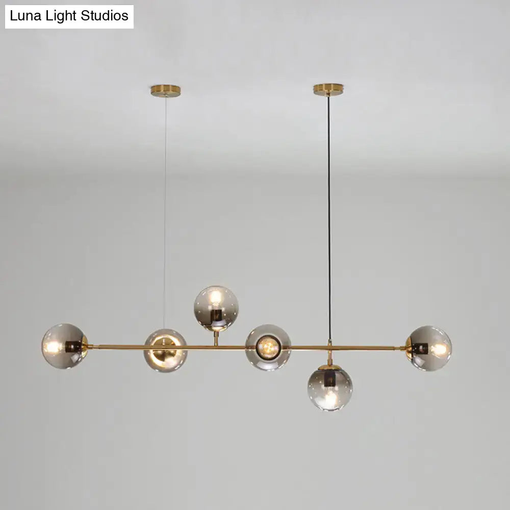 Modern gold and smoke gray globe hanging light – dining room island