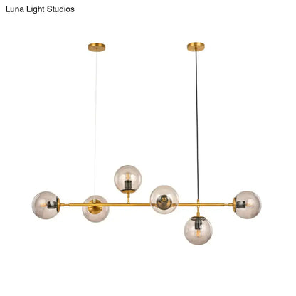 Modern gold and smoke gray globe hanging light – dining room island