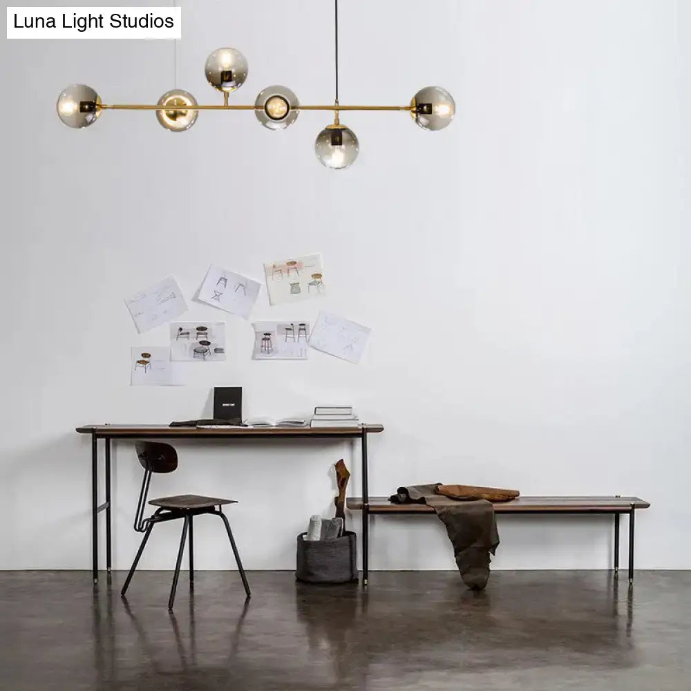 Modern gold and smoke gray globe hanging light – dining room island