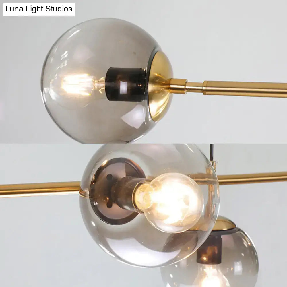 Modern gold and smoke gray globe hanging light – dining room island
