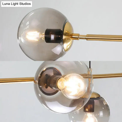 Modern gold and smoke gray globe hanging light – dining room island