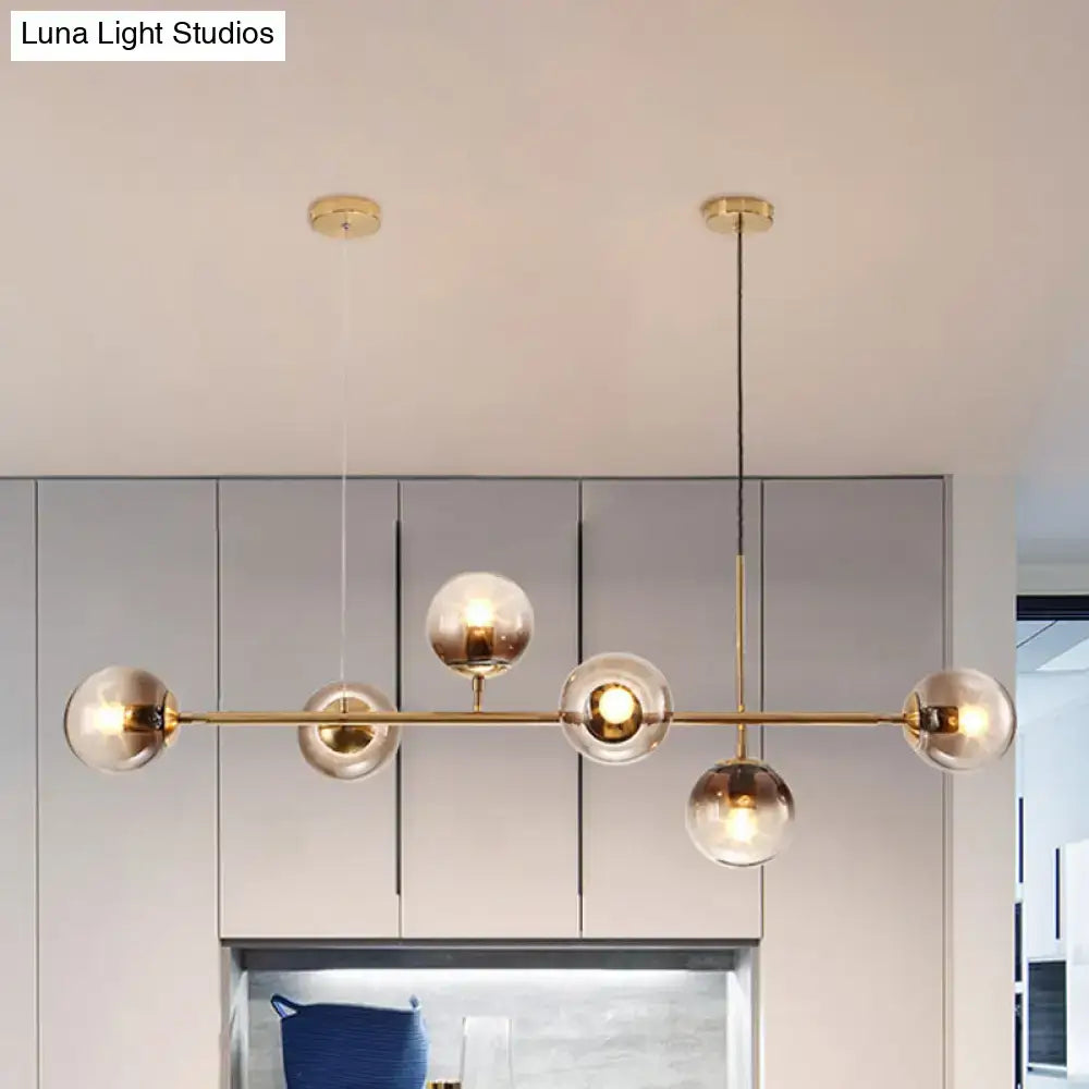 Modern gold and smoke gray globe hanging light – dining room island