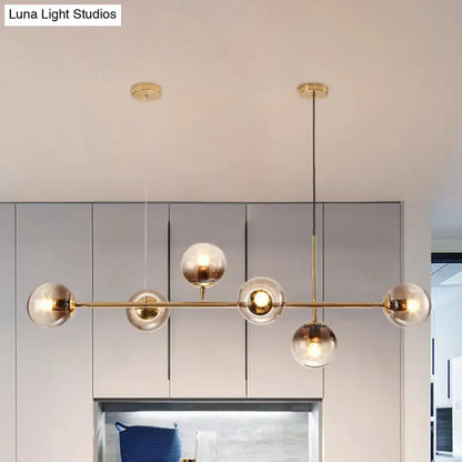 Modern gold and smoke gray globe hanging light – dining room island
