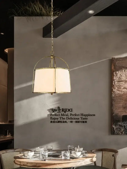 Modern gold & black pendant lights with fabric shades dining room