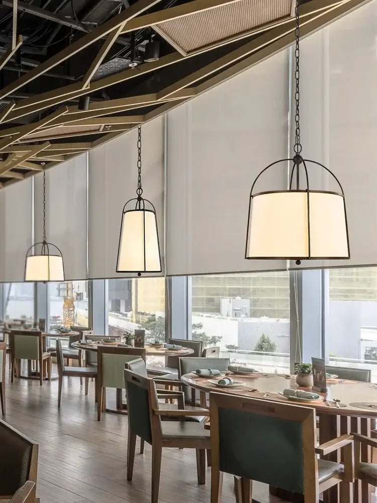 Modern gold & black pendant lights with fabric shades dining room