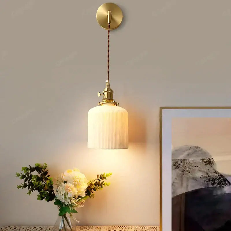 Modern gold ceramic wall lamp with ribbed shade for bedroom