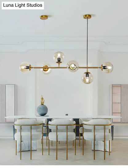 Modern gold island pendant light with glass globes for dining room