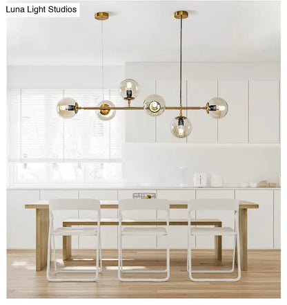 Modern gold island pendant light with glass globes for dining room