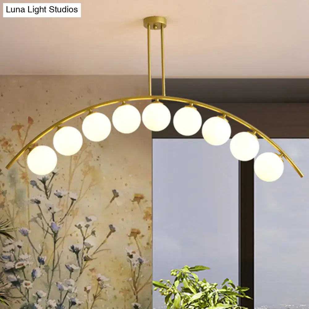 Modern gold island pendant with clear white shade for kitchens