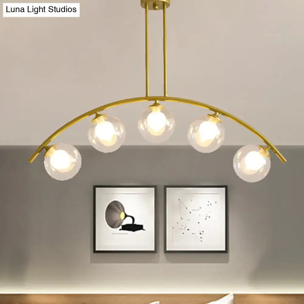 Modern gold island pendant with clear white shade for kitchens