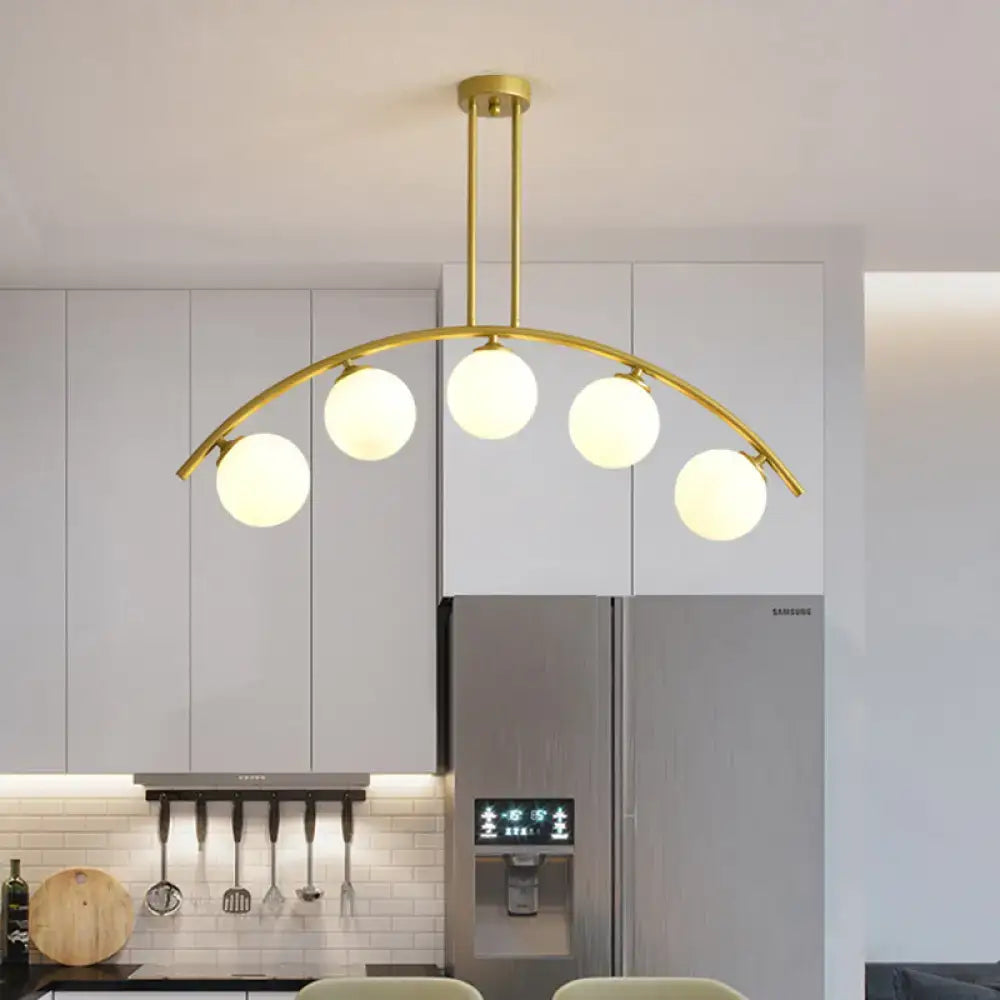 Modern gold island pendant with clear white shade for kitchens