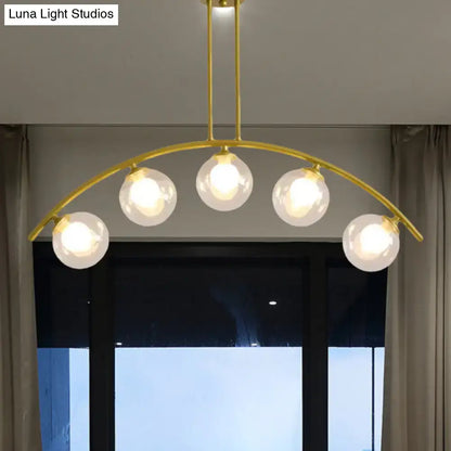 Modern gold island pendant with clear white shade for kitchens