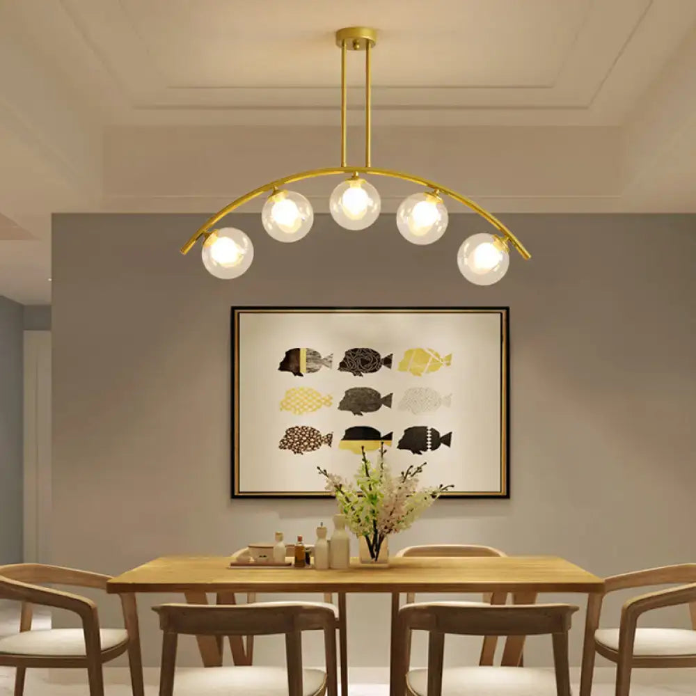 Modern gold island pendant with clear white shade for kitchens