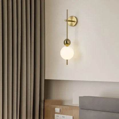 Modern gold led wall sconce with frosted glass spheres for bedroom