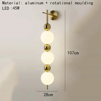 Modern gold led wall sconce with frosted glass spheres for bedroom