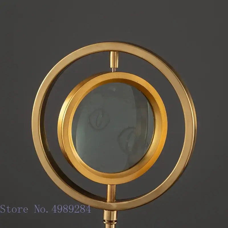 Modern gold metal eye magnifying glass with glass base living room decor