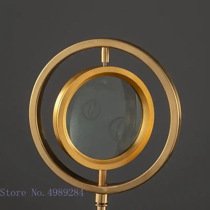 Modern gold metal eye magnifying glass with glass base living room decor