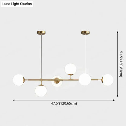 Modern gold metal island pendant with blue glass spheres dining room